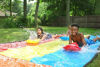 Picture of Jambo Triple Lane Slip, Splash and Slide for Backyards | Water Splash Slide Waterslide with 3 Boogie Boards | 16 Foot Three Sliding Racing Lanes with Sprinklers | Durable Quality PVC Construction