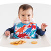 Picture of Tiny Twinkle Mess Proof Baby Bib - Waterproof Baby Apron - Machine Washable - PVC, BPA, & Phthalate Free - Great Travel Bib for Baby Eating - Baby Food Bibs (Dino Primary, Large 2-4 Years)