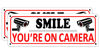 Picture of Smile You're on Camera Sign (2 Pack), Video Surveillance Sign Metal, 10" x 3.5" Home Security Signs for House Business, Camera Warning Sign Outdoor, Aluminum CCTV Sign for Yard (You're on Camera Sign-C01C)