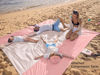 Picture of WEKAPO Beach Blanket Sandproof, Extra Large Beach Mat, Big & Compact Sand Free Mat Quick Drying, Lightweight & Durable with 6 Stakes & 4 Corner Pockets (Pink, 7x7 FT (1～3 Person))