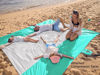 Picture of WEKAPO Beach Blanket Sandproof, Extra Large Beach Mat, Big & Compact Sand Free Mat Quick Drying, Lightweight & Durable with 6 Stakes & 4 Corner Pockets (Turquoise, 7x7 FT (1～3 Person))