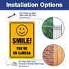 Picture of (2 Pack) Smile You're On Camera Video Surveillance Sign - 10 x7 Inches .040 Rust Free Heavy Duty Aluminum - Indoor or Outdoor Use for Home Business CCTV Security Camera,UV Protected & Reflective